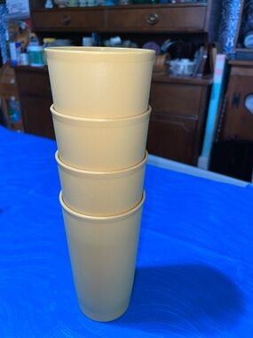 Four light gold-colored Tupperware tumblers, 14 oz each